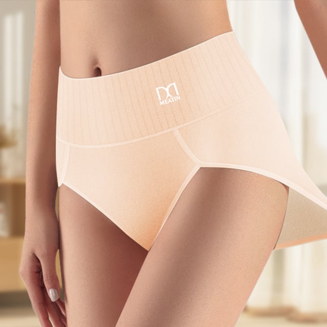 Woman wearing black high-waist shaping briefs showing smooth, sculpted silhouette from the front
