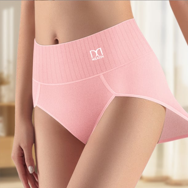 Woman in grey high-waist shaping briefs demonstrating tummy control and comfortable fit