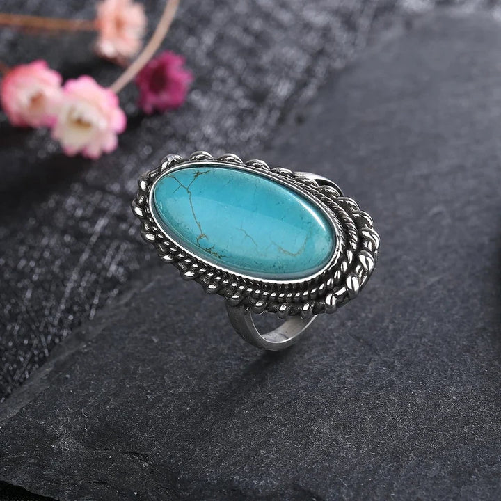 Close-up of a vibrant turquoise statement ring with an elegant detailed setting