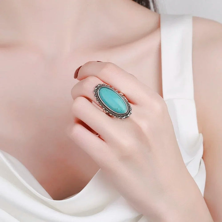 Turquoise ring styled alongside other stacked rings for a layered boho look