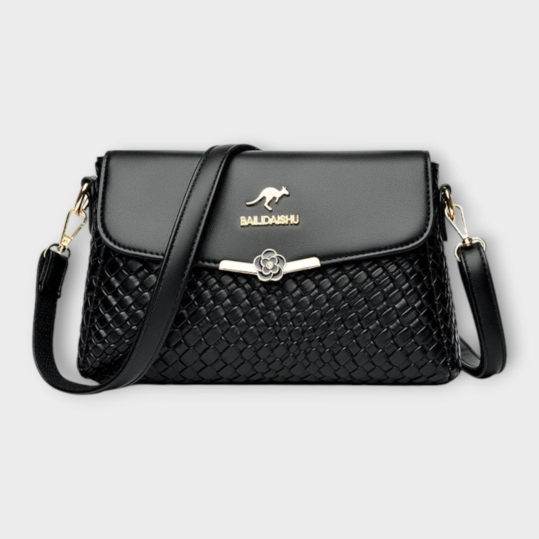 Selinda elegant shoulder bag in black with refined detailing and a comfortable shoulder strap