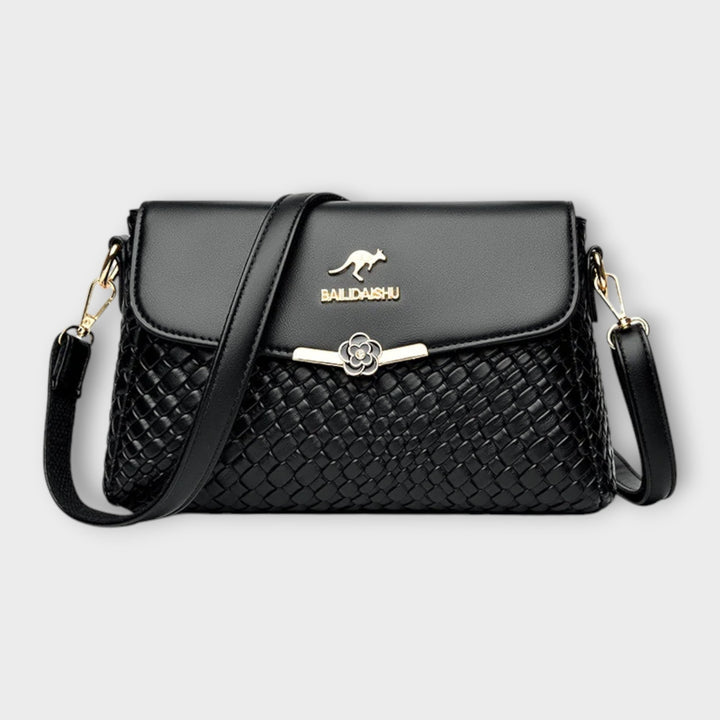 Selinda elegant shoulder bag in black with refined detailing and a comfortable shoulder strap