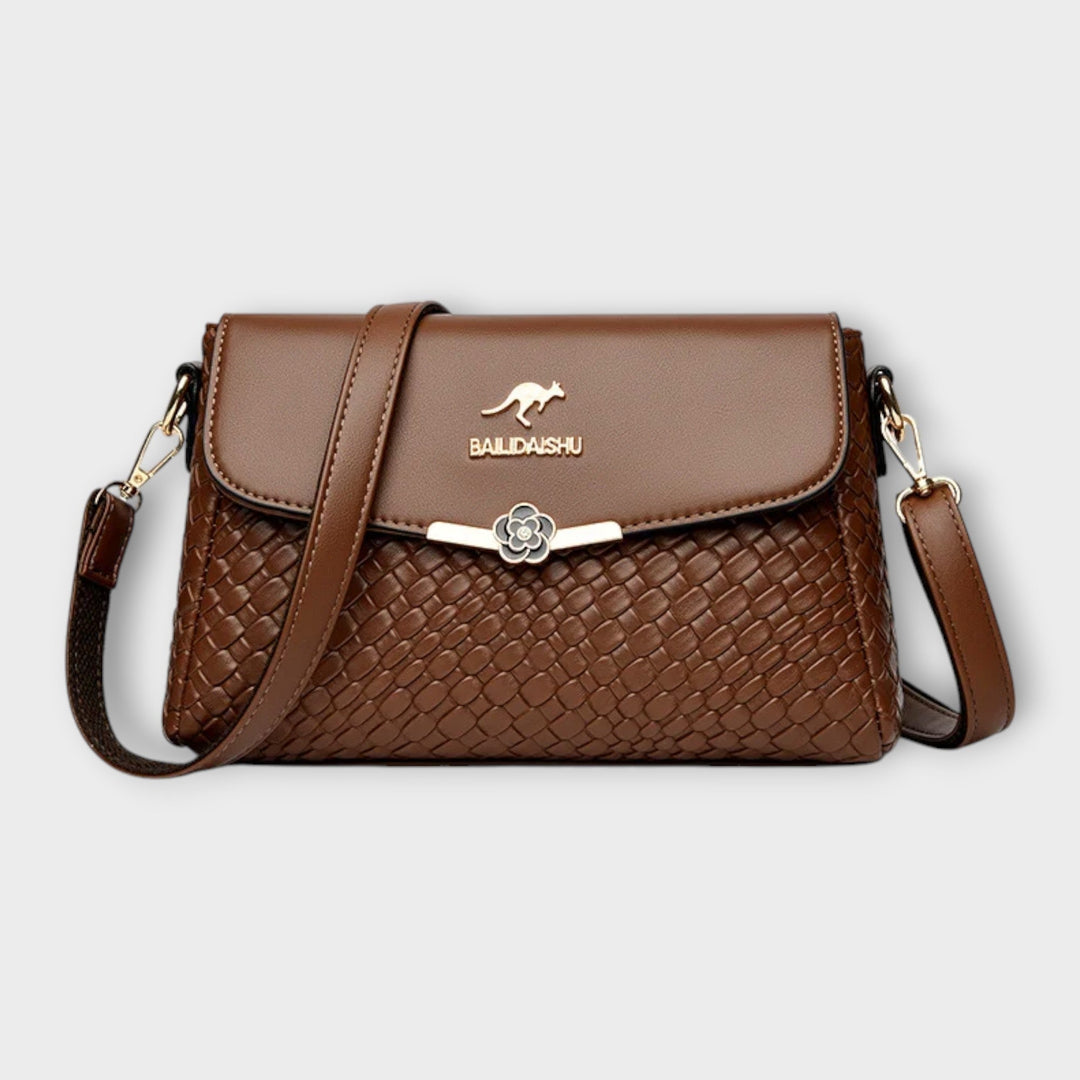 Close-up of the Selinda shoulder bag showing feminine details and structured silhouette