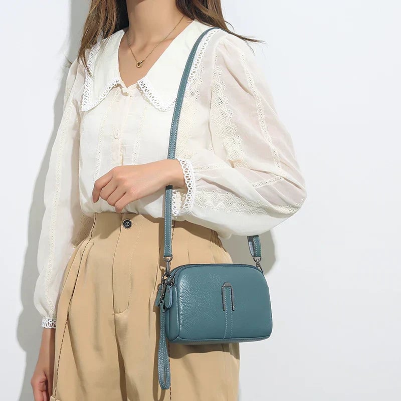Selinde shoulder bag in green shown as a clutch with strap removed