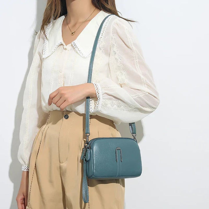 Selinde shoulder bag in green shown as a clutch with strap removed