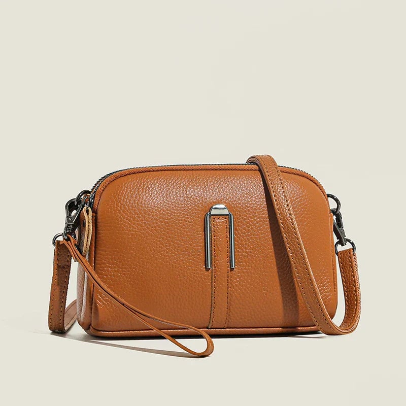 Close-up of Selinde shoulder bag in blue highlighting polished hardware and clean lines