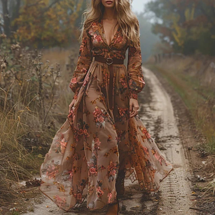Back view of model wearing a flowing floral maxi dress in dark brown with structured collar detail