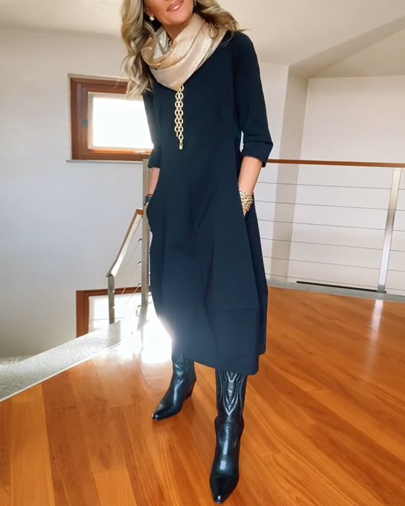 Side view of the Seraphina dress in black showing the draped lightweight fabric