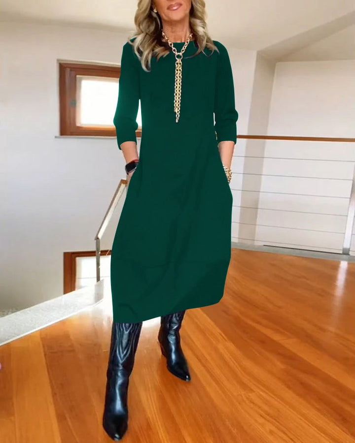 Lifestyle image of the Seraphina elegant flattering dress in green outdoors