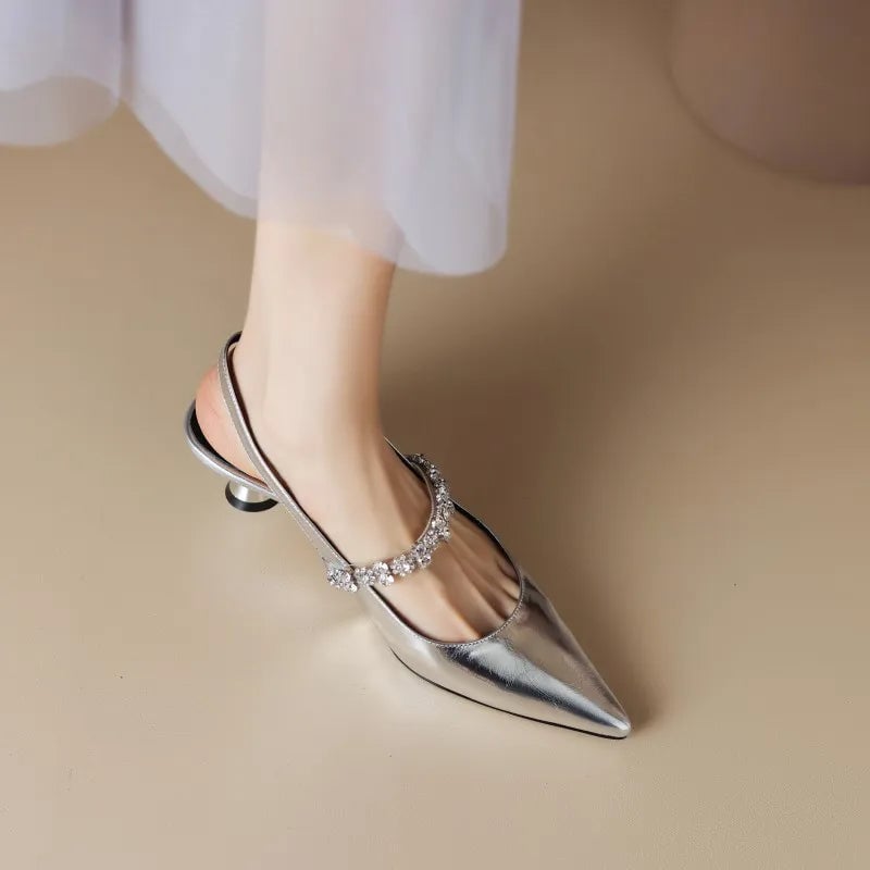 Close-up of crystal-embellished instep strap on silver slingback pump