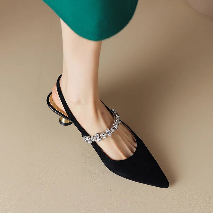 Pair of silver Seraphina slingback heels side by side on a neutral surface