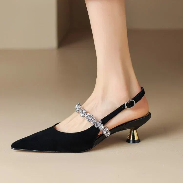 Close-up of crystal embellishments on black slingback instep strap
