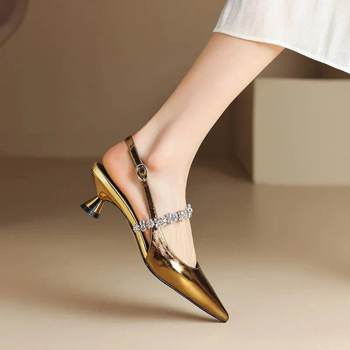 Close-up of sparkling crystal strap detail on gold slingback pump