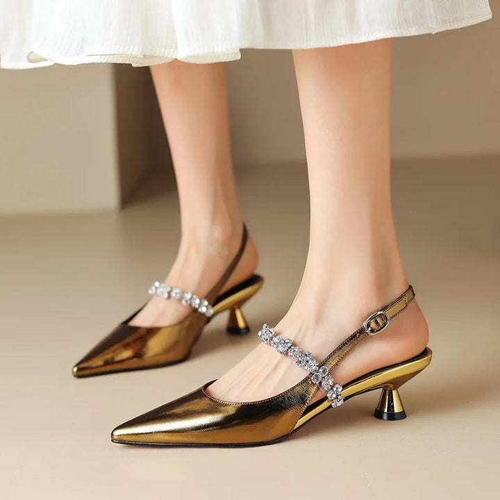 Side profile of gold Seraphina pointed toe slingback heel