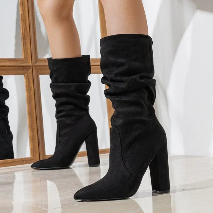 Model wearing Florimay Serena slouchy boots in black paired with skinny jeans