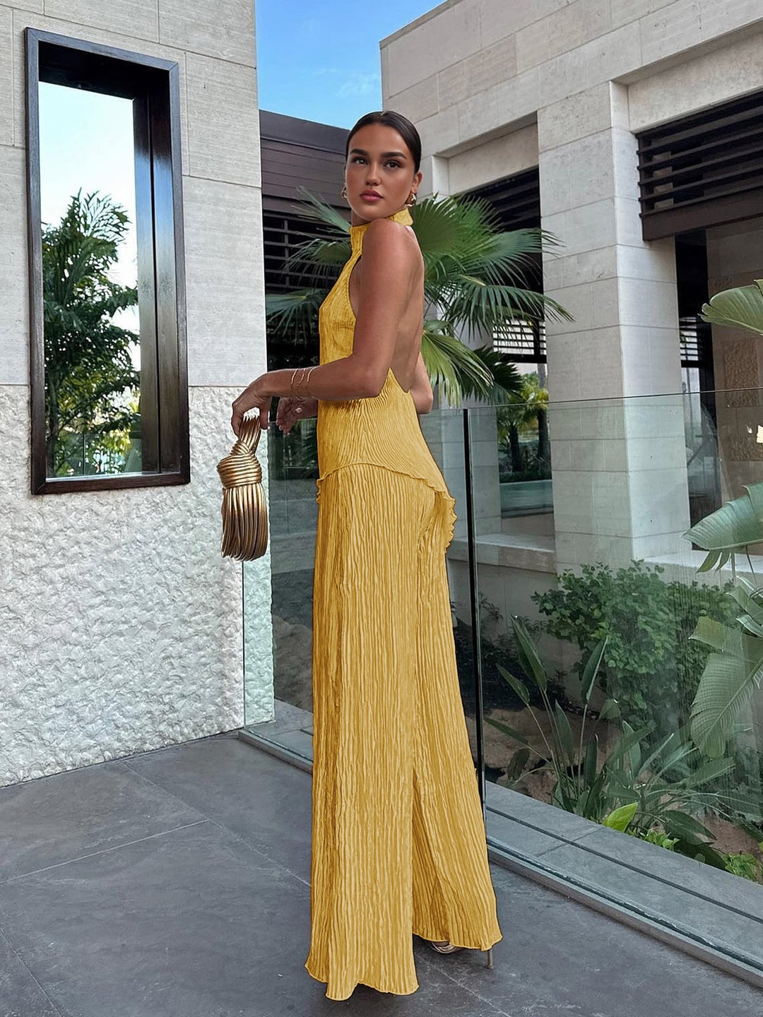 Woman posing in black Serena pleated halter neck and wide leg pants set, front view