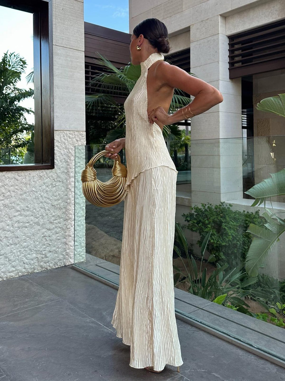 Woman wearing dark green Serena halter neck pleated co-ord set, front view