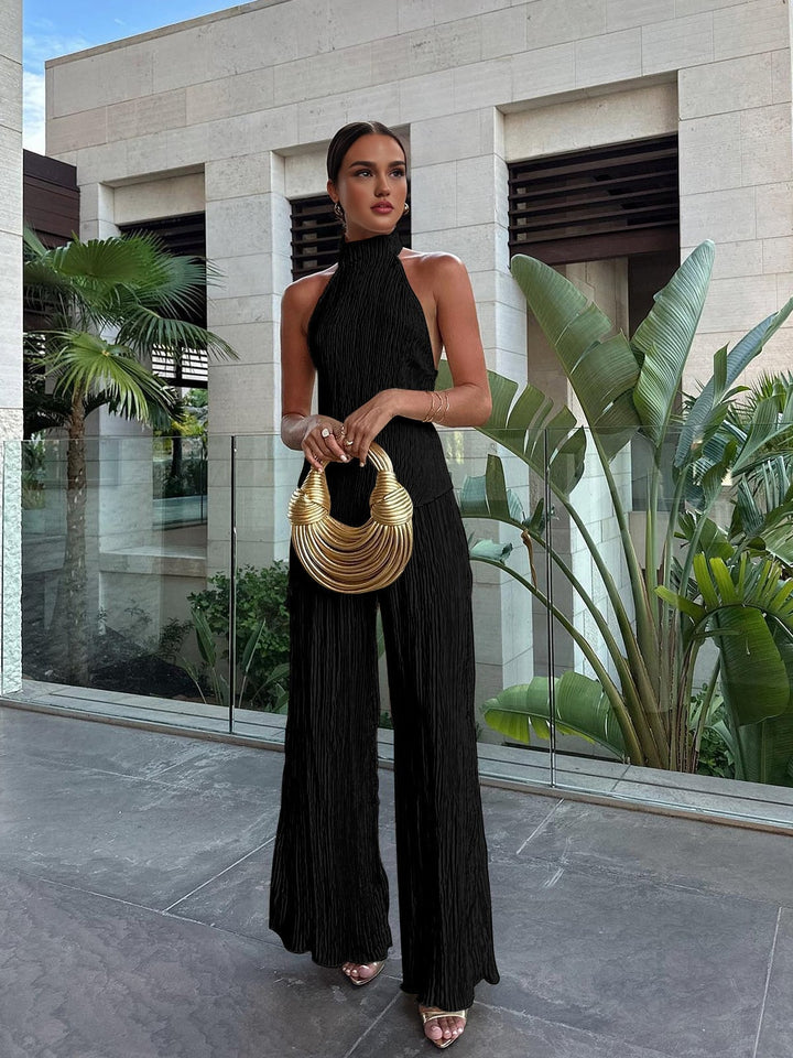Woman posing in red Serena halter neck pleated top and wide-leg pants set, front view