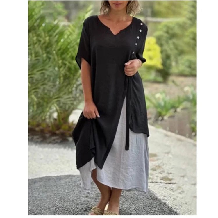 Close-up of the asymmetric layered hem and contrasting underlayer detail on the Serena midi dress in black