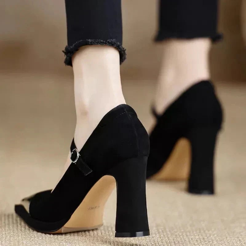 Serena all-black cap toe pump, rear view showing structured block heel