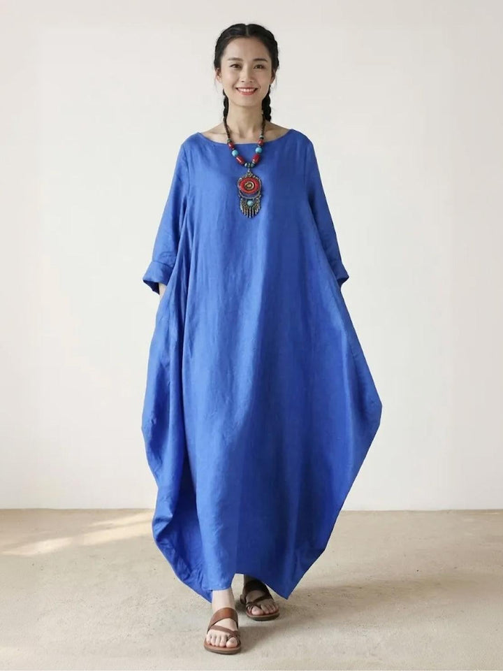 Woman wearing the Serena oversized boho maxi dress in Royal Blue with batwing 3/4 sleeves and floor-length hem, front view