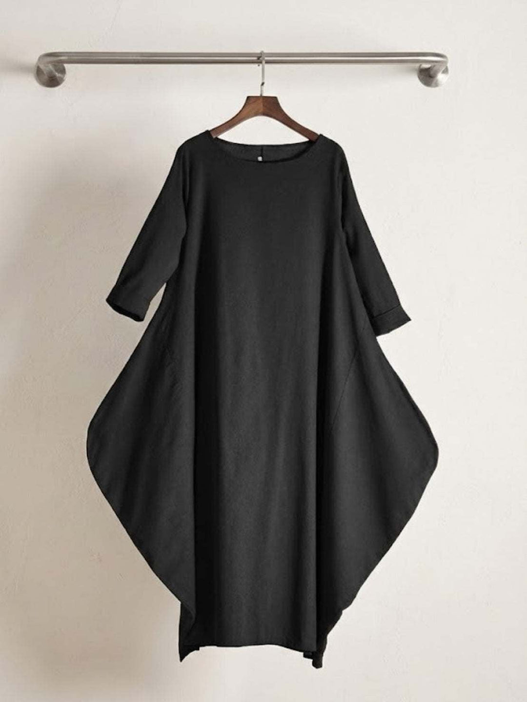 Full-length shot of woman in the Serena maxi dress in Dark Green with sandals