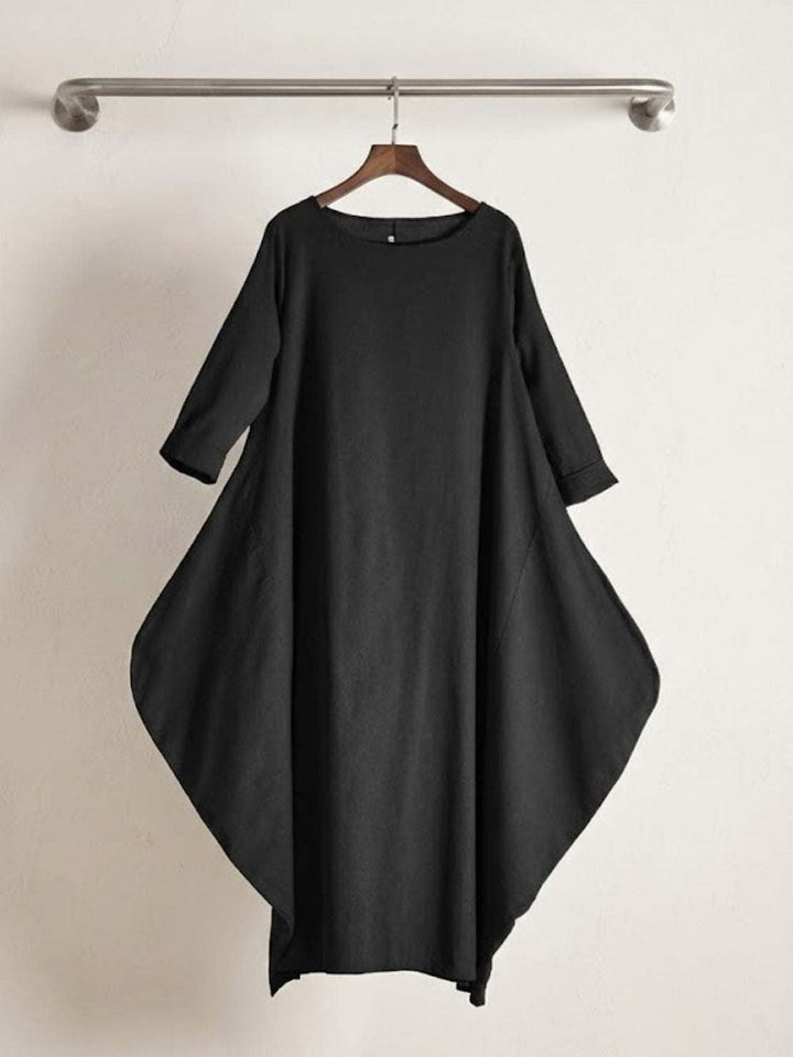 Full-length shot of woman in the Serena maxi dress in Dark Green with sandals