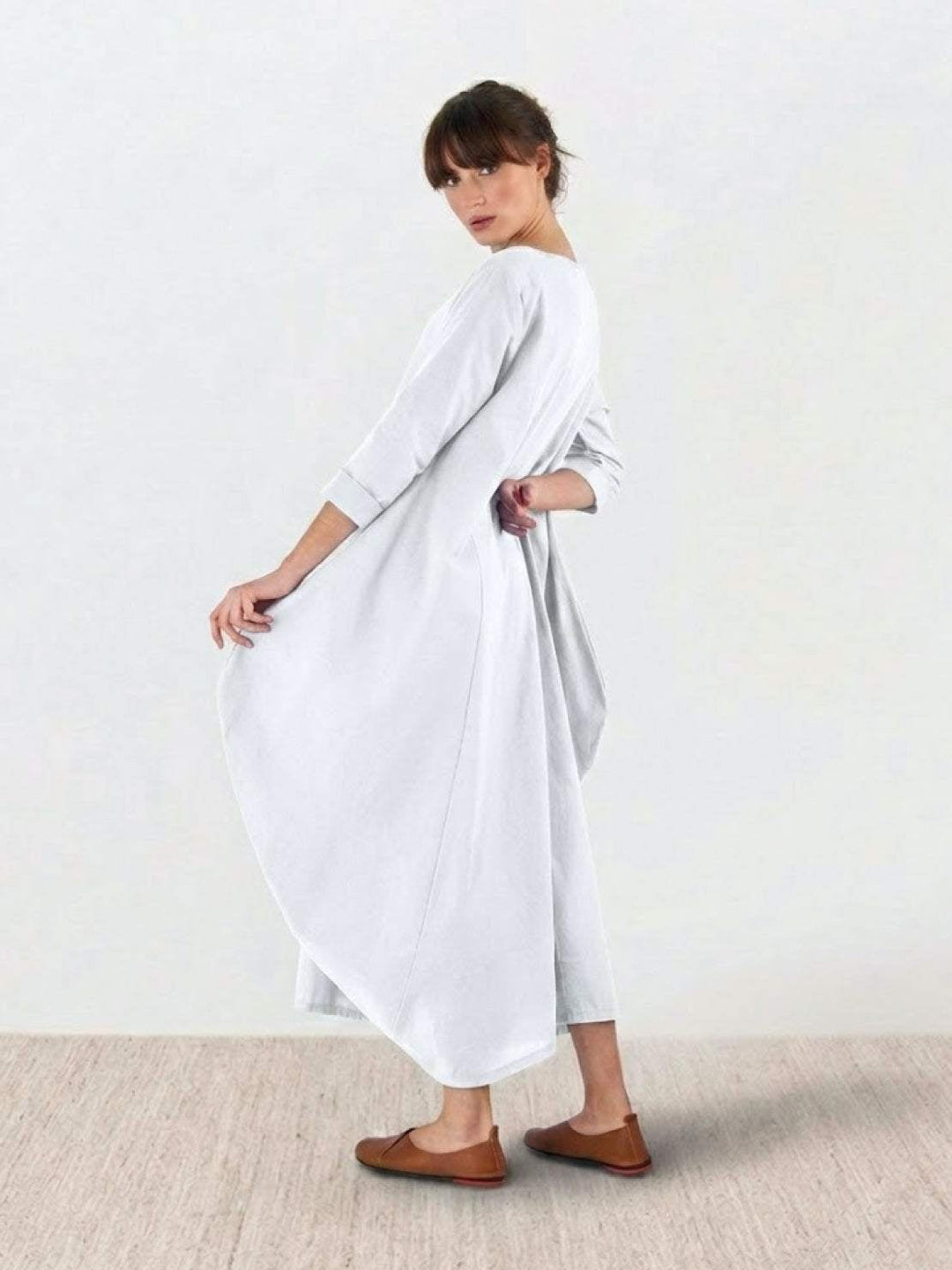 Group flat lay of the Serena maxi dress in multiple color options including Black and Dark Green
