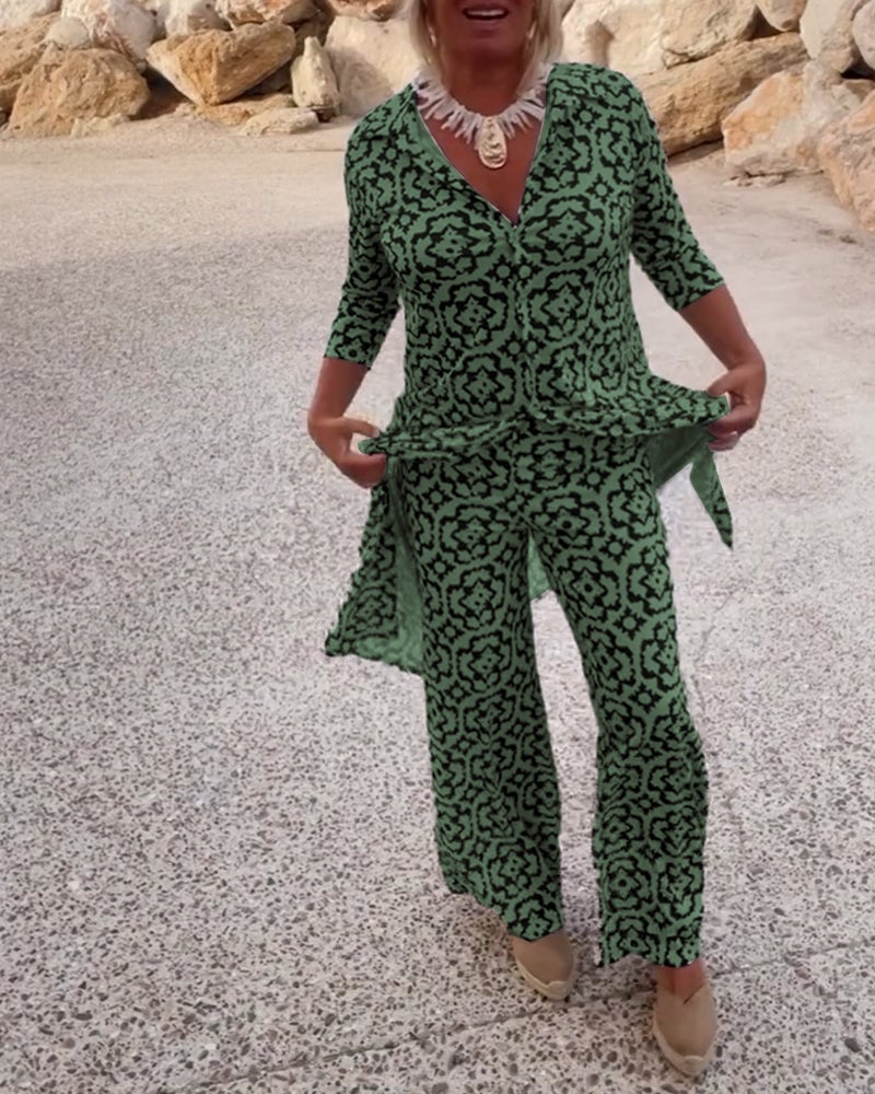 Woman wearing the Serena fuchsia geometric print two-piece blouse and pants set