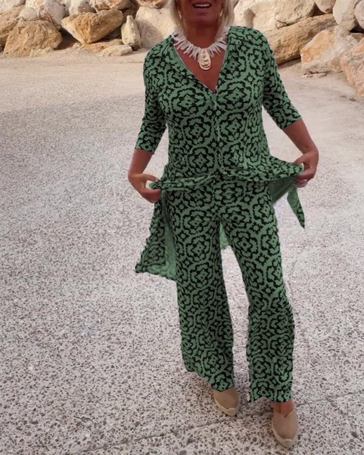 Woman wearing the Serena fuchsia geometric print two-piece blouse and pants set
