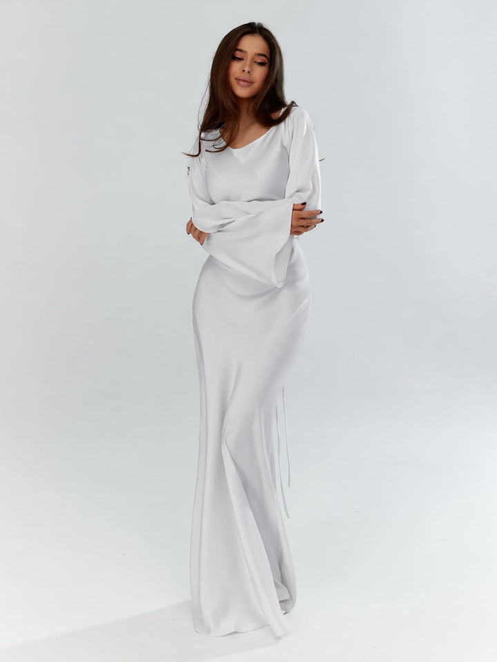 Woman wearing the Serena ivory satin long sleeve maxi gown, front view, floor-length silhouette