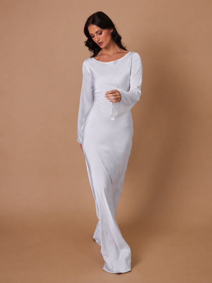 Woman in Serena ivory satin maxi dress, three-quarter angle highlighting elongated silhouette
