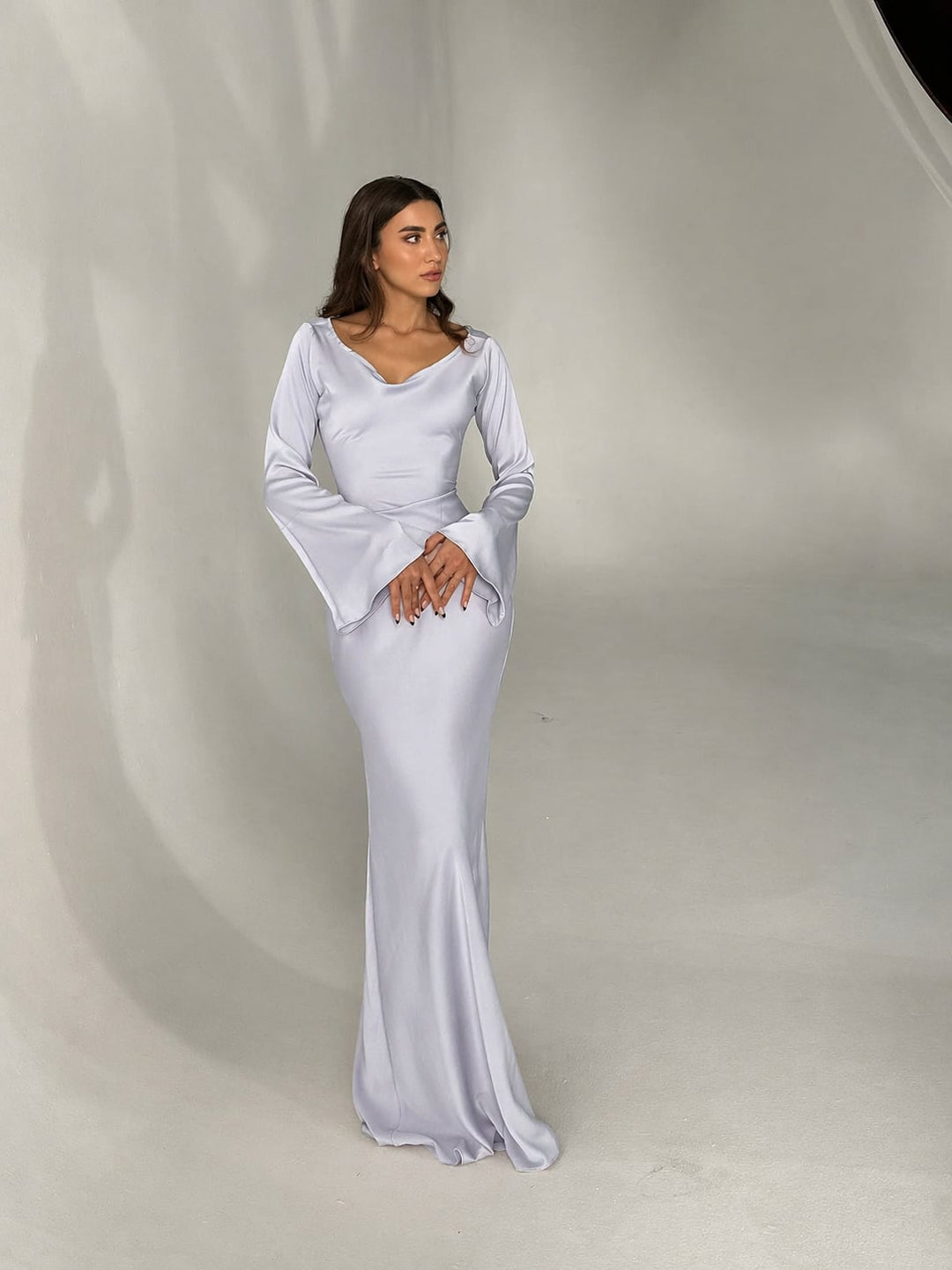 Close-up of Serena black satin maxi gown draped sleeve and sheen fabric detail