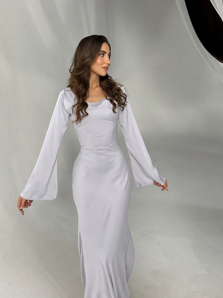 Back view of Serena black satin formal gown, flowing floor-length skirt