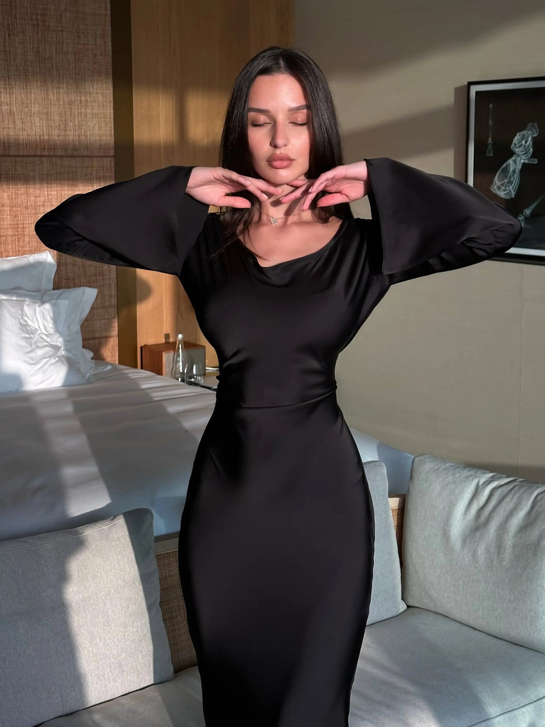 Full-length side profile of Serena black satin gown highlighting floor-sweeping length