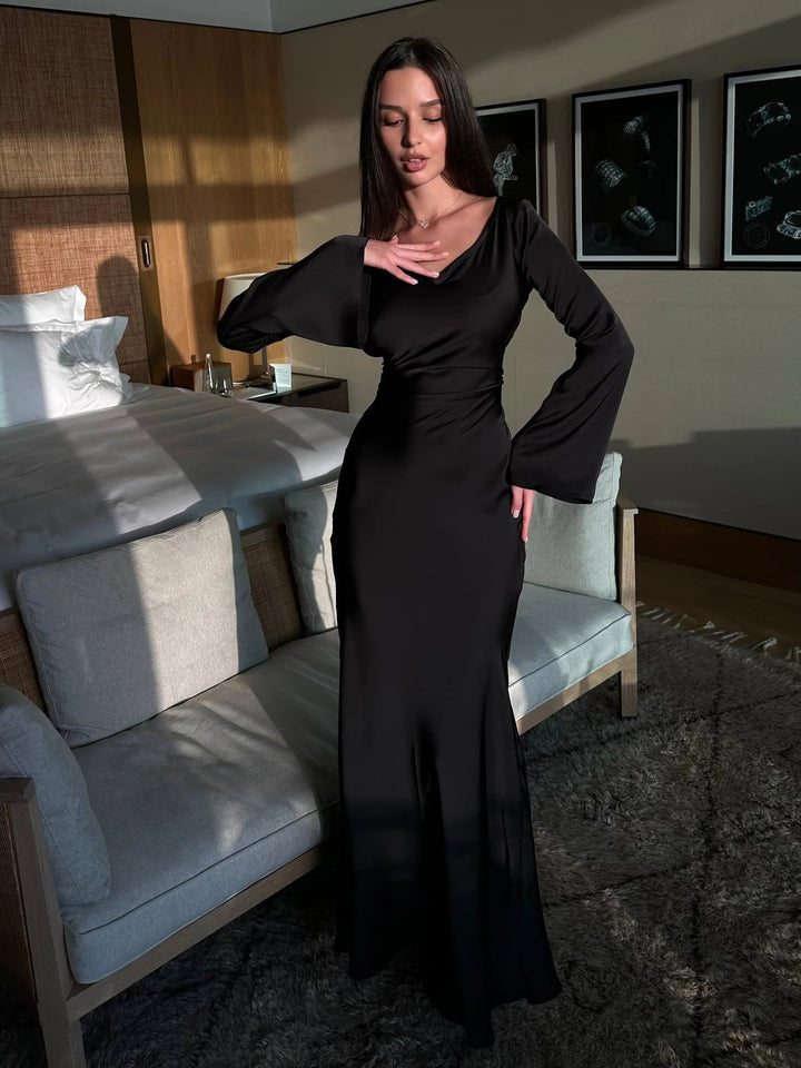 Woman wearing the Serena wine red satin long sleeve maxi dress, front view