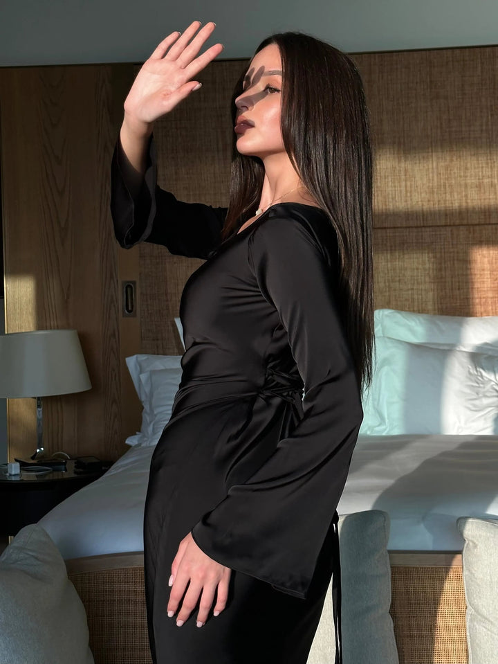 Close-up of Serena wine red satin maxi gown sleeve drape and lustrous finish