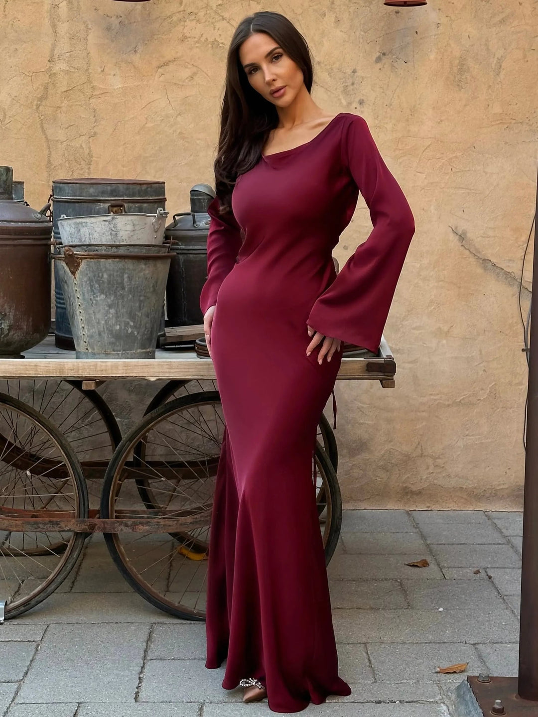 Back view of Serena wine red satin formal gown with gracefully flowing skirt