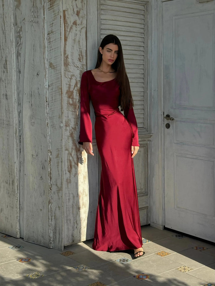 Three-quarter angle of Serena wine red satin maxi dress showing elegant silhouette