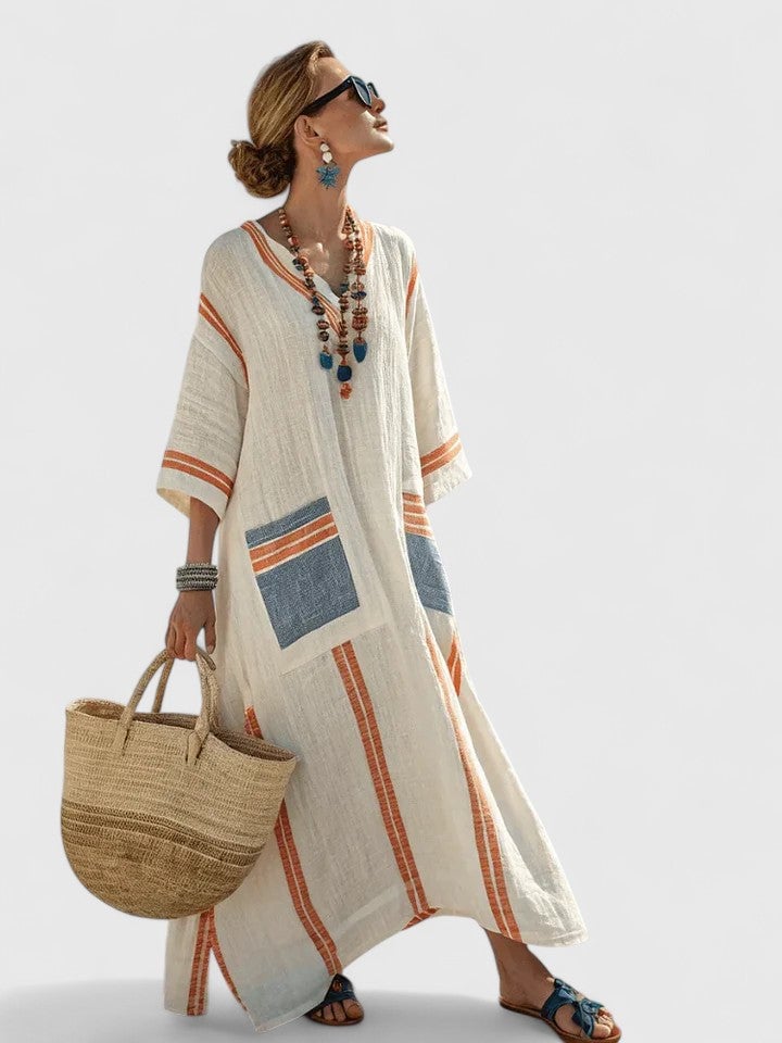 Detail shot of the deep V-neckline on the Serena kaftan maxi dress in beige yellow colorway