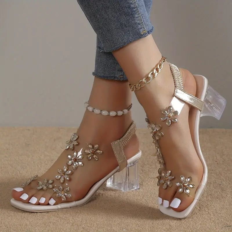 Model wearing Serene champagne golden rhinestone block heel sandals styled with an elegant dress