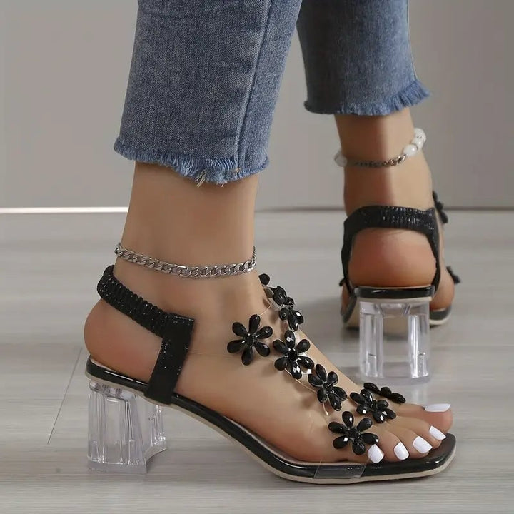 Model wearing Serene black rhinestone block heel sandals styled for an evening occasion