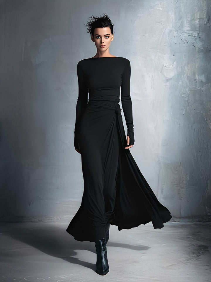 Model in a black wrap maxi dress styled with heeled sandals for an evening look