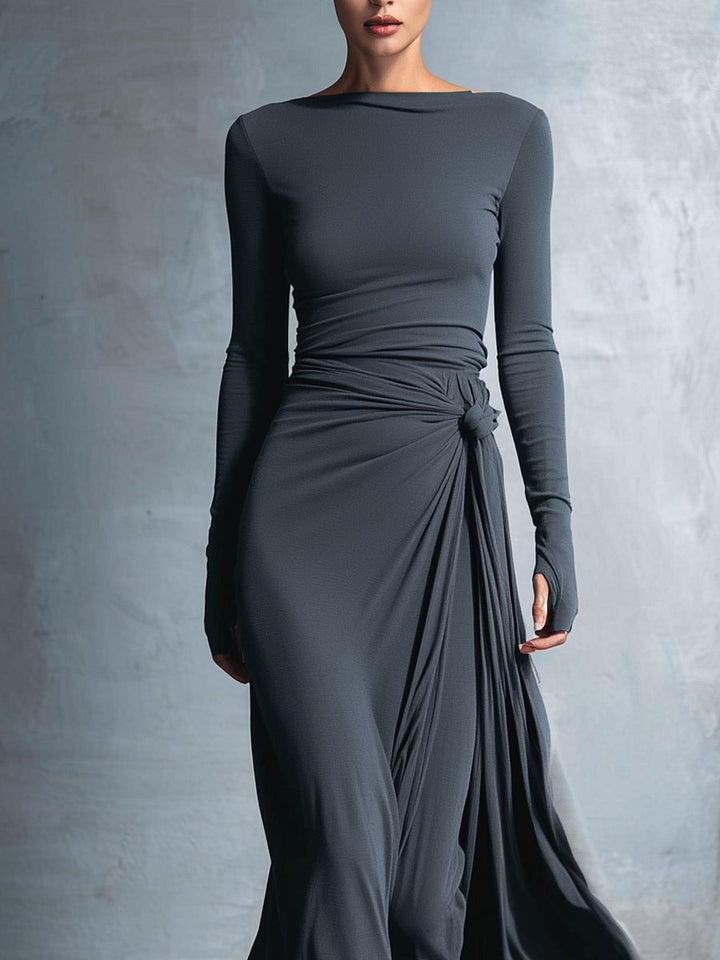 Side profile of a woman in a grey wrap maxi dress highlighting the elongating maxi cut