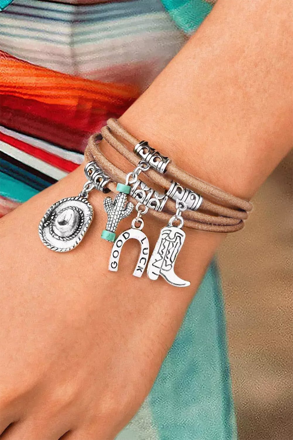 Silver-tone multi-layered cactus charm bracelet on a neutral background