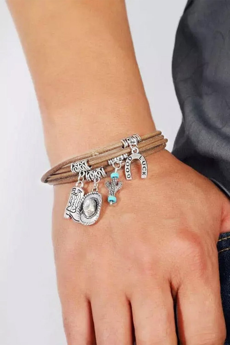 Close-up of the cactus charm detail on the silver multi-layered bracelet