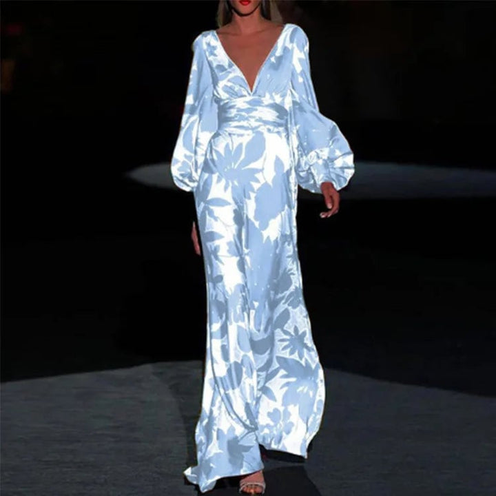 Close-up detail of the bold botanical floral print and cinched puff sleeve cuff on the Seste satin maxi dress