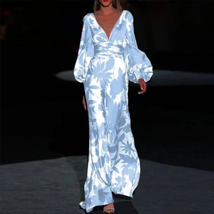 Close-up detail of the bold botanical floral print and cinched puff sleeve cuff on the Seste satin maxi dress