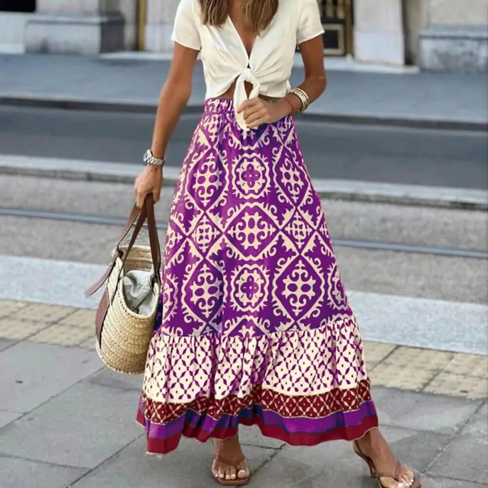 Close-up of the contrast border and ruffle hem detail on a floral print boho maxi skirt in purple