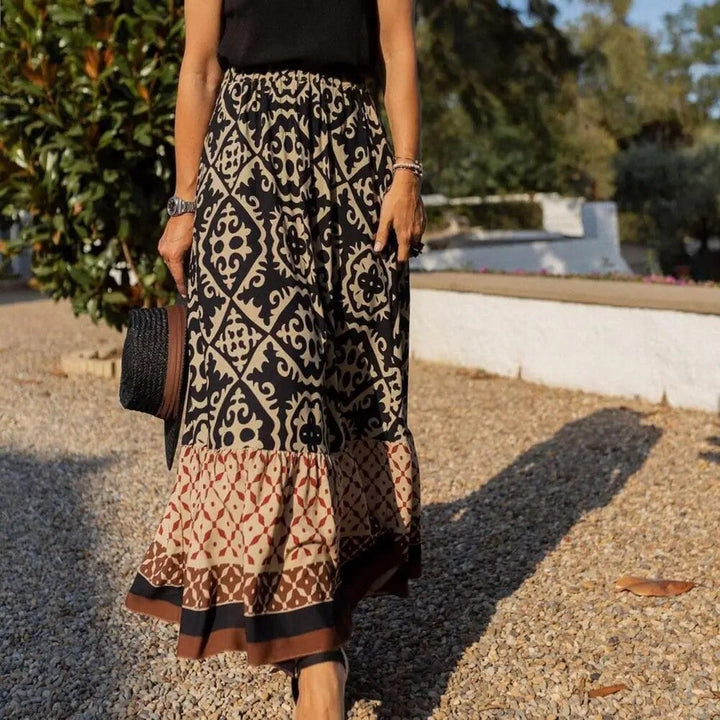 Black high-waist boho maxi skirt with tile medallion print and gathered ruffle hem, styled casually